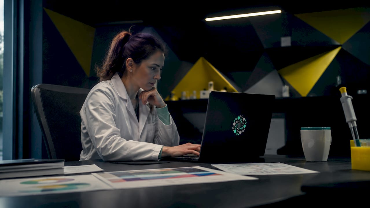 Scientist analyzing bioinformatics data on laptop
