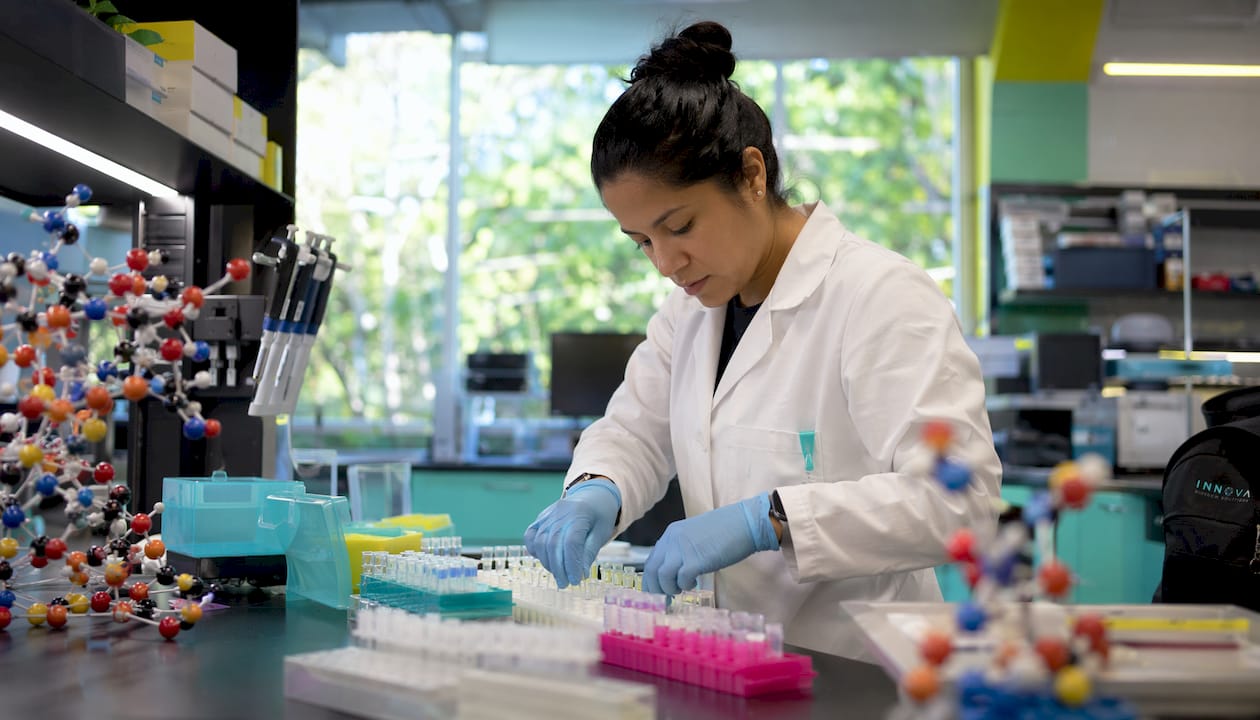 Researcher pipetting protein samples in lab