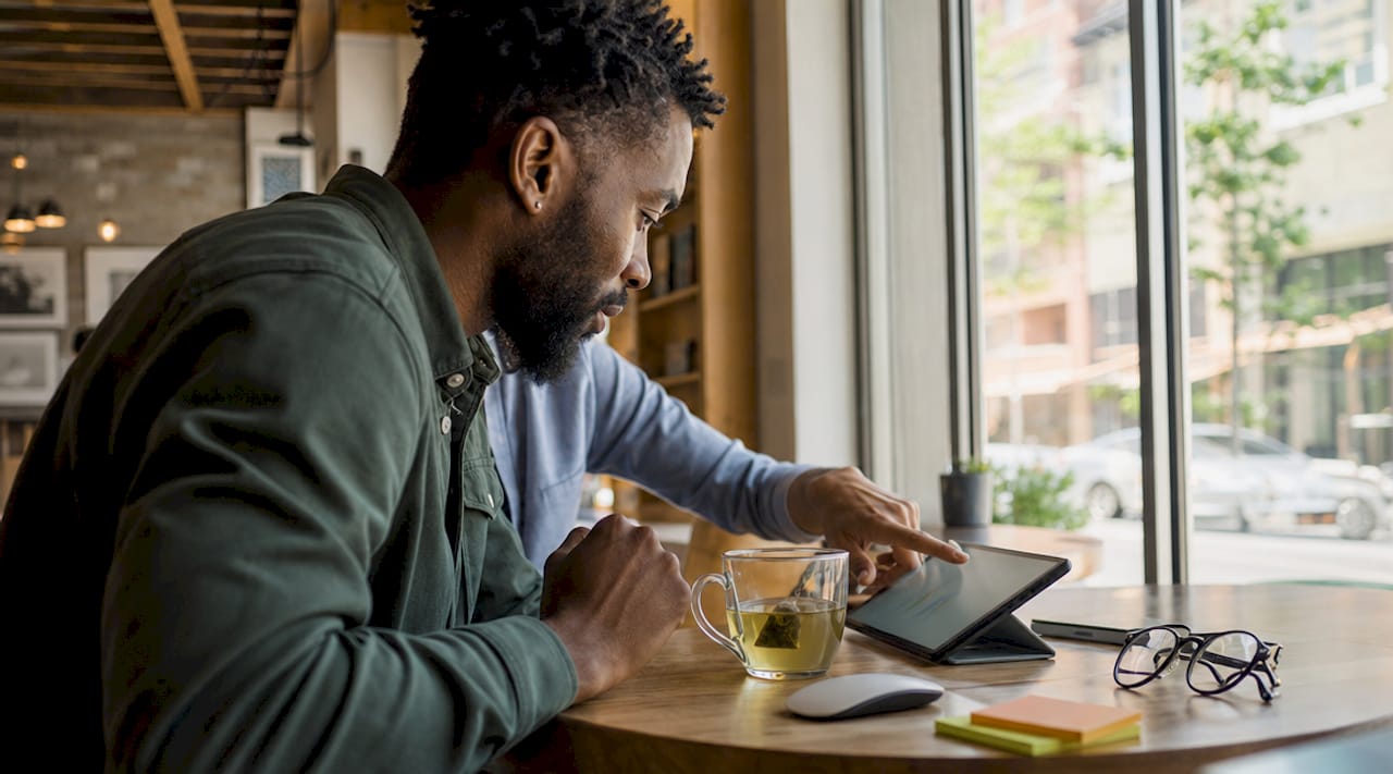 Young man analyzing digital marketing channels on tablet