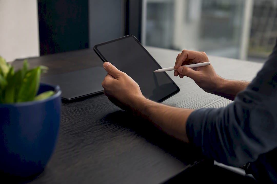 Hands pointing at data tools on desk