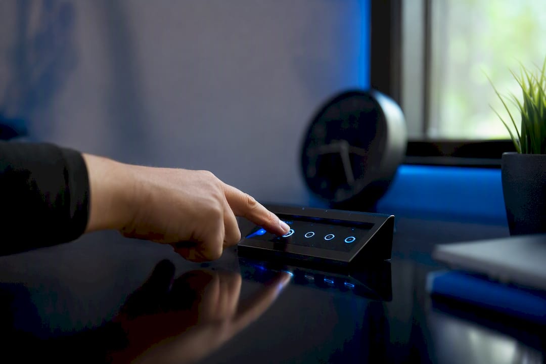Hand pressing button on automation control device