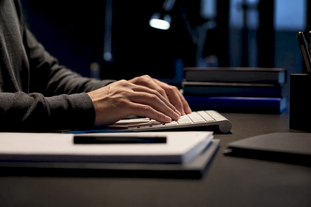 Hands typing backend keyword data on keyboard