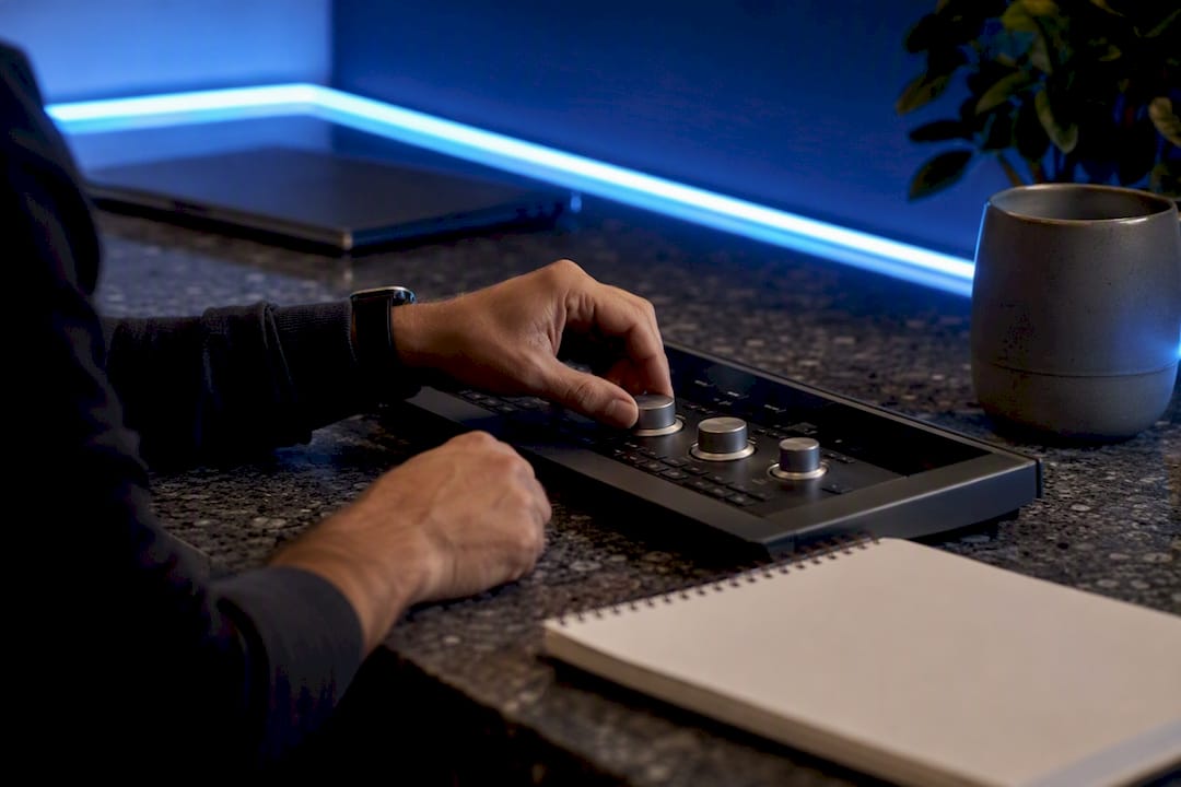 Hands adjusting analog controls on panel