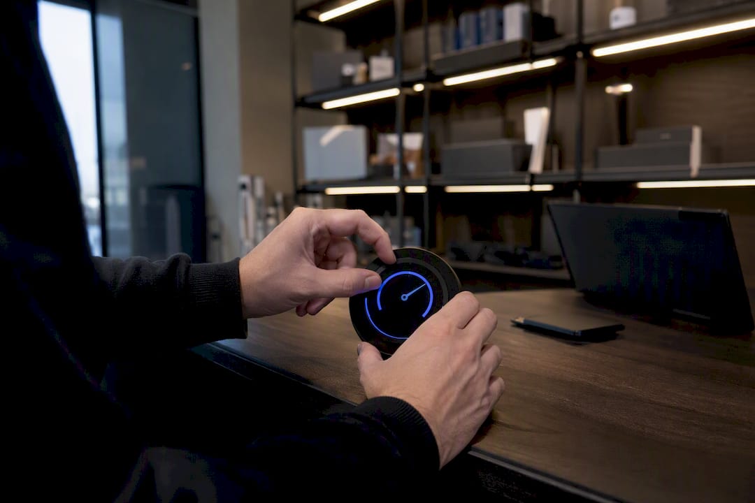 Hands adjusting analog counter dial