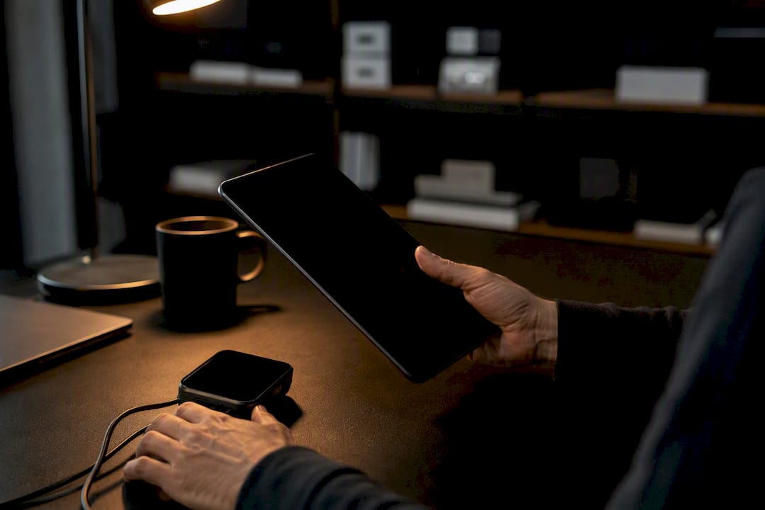 Hands holding phone with screen off in tech setting