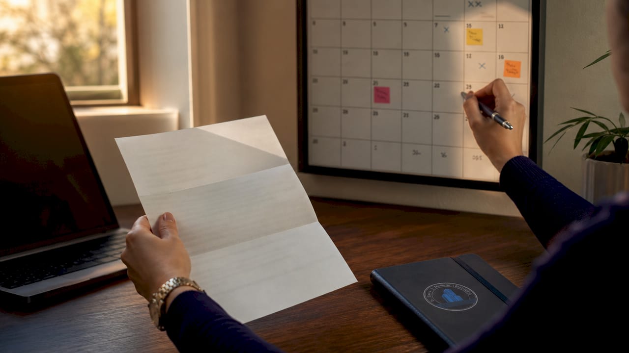 Hands marking dates on eviction notice calendar