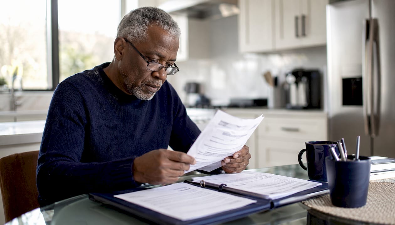 Hands organizing foreclosure legal documents