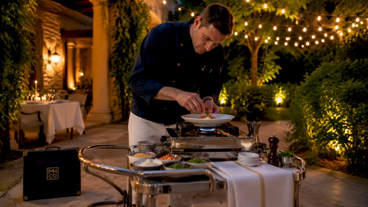 Chef preparing dish at restaurant tableside trolley
