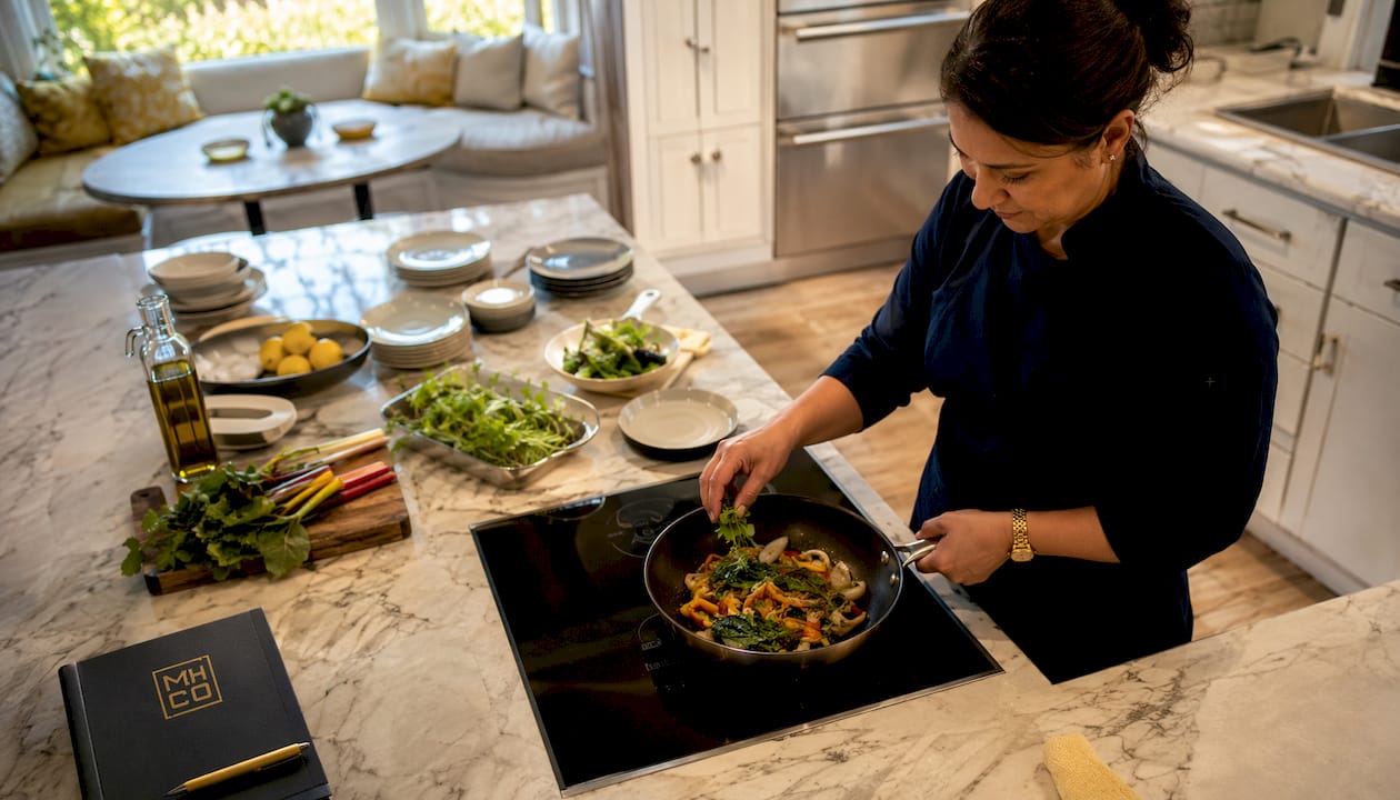 Chef plating gourmet dinner in home kitchen