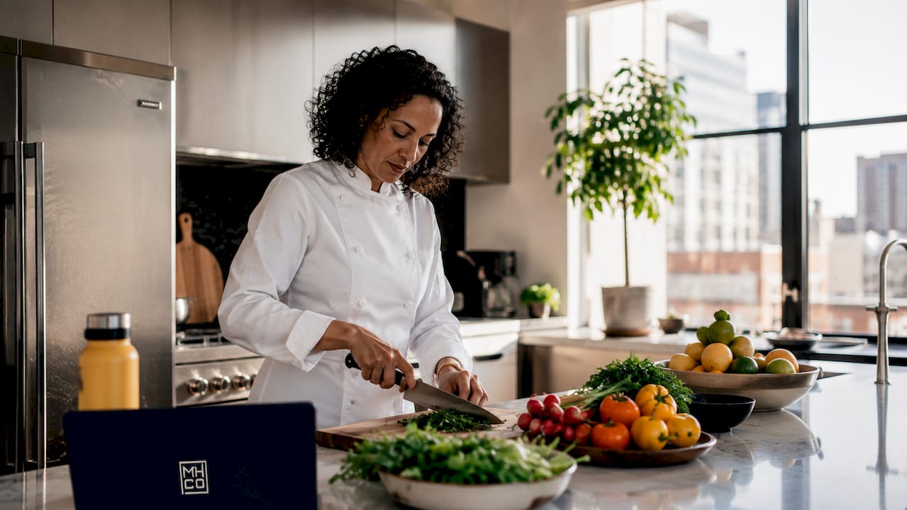 Chef plating gourmet meal in kitchen