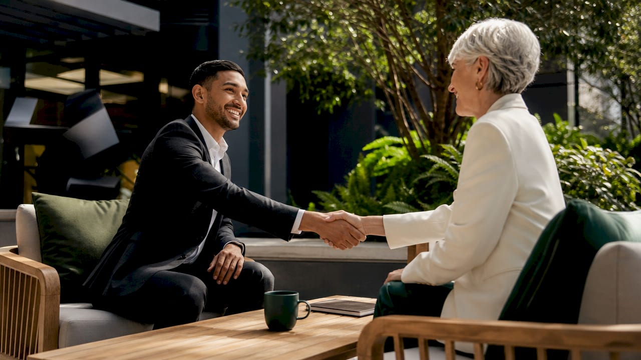 Buyer and agent handshake symbolizing trust