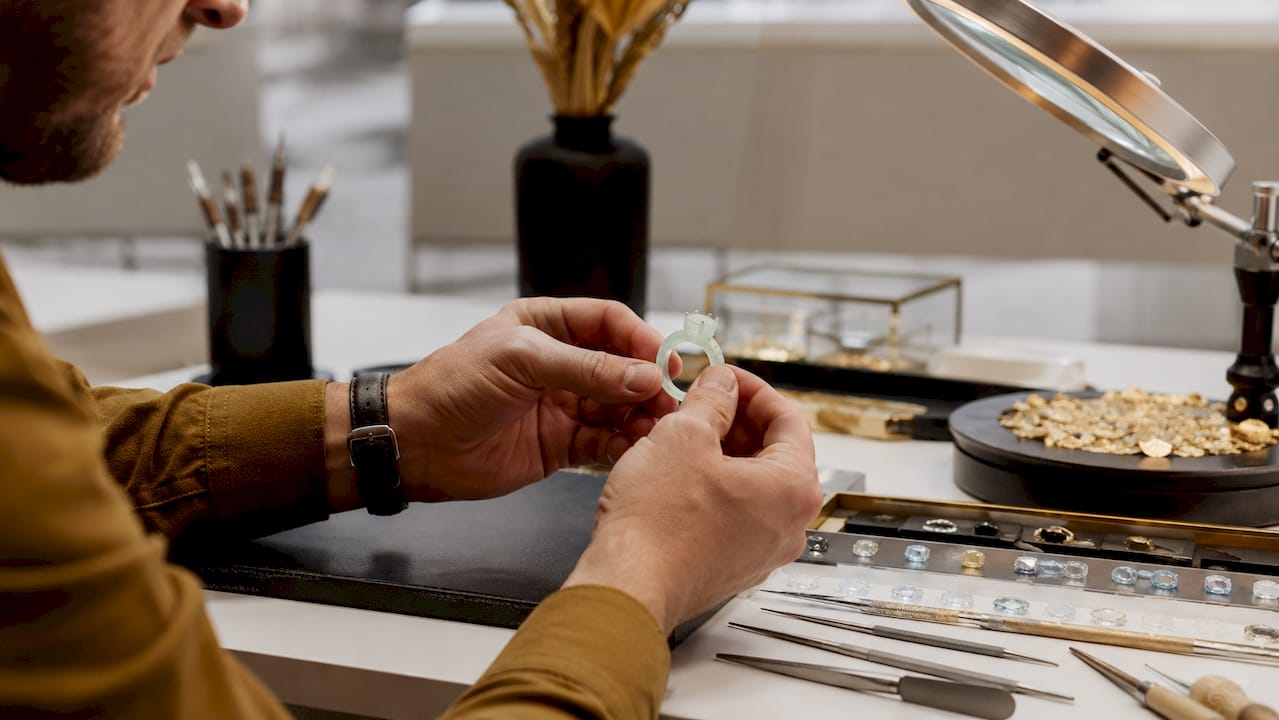 Jeweler holding wax resin engagement ring prototype