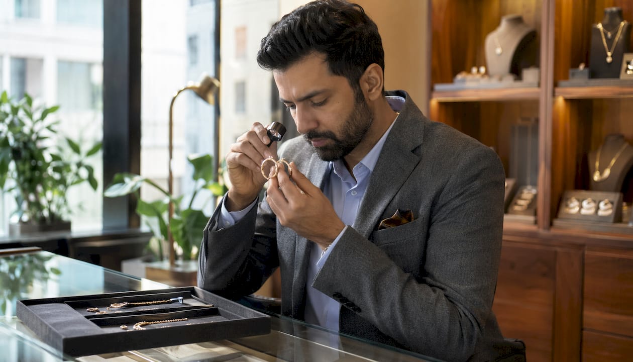 Jewelry buyer inspecting affordable luxury earrings