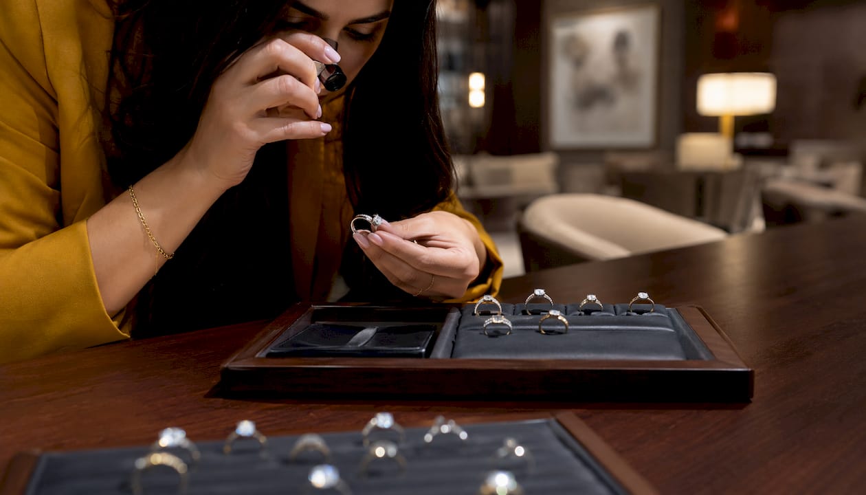 Close-up of diamond ring inspection in boutique