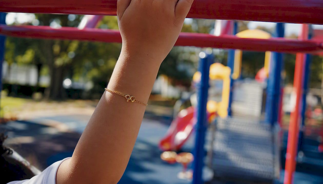 Child's wrist with lobster clasp bracelet in play