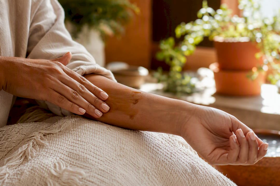 Applying seed oil on forearm skin