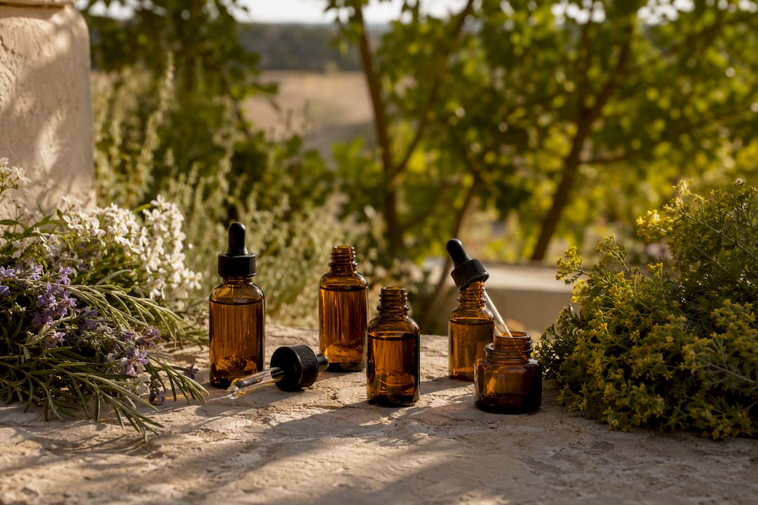 Amber essential oil bottles on rustic wood table