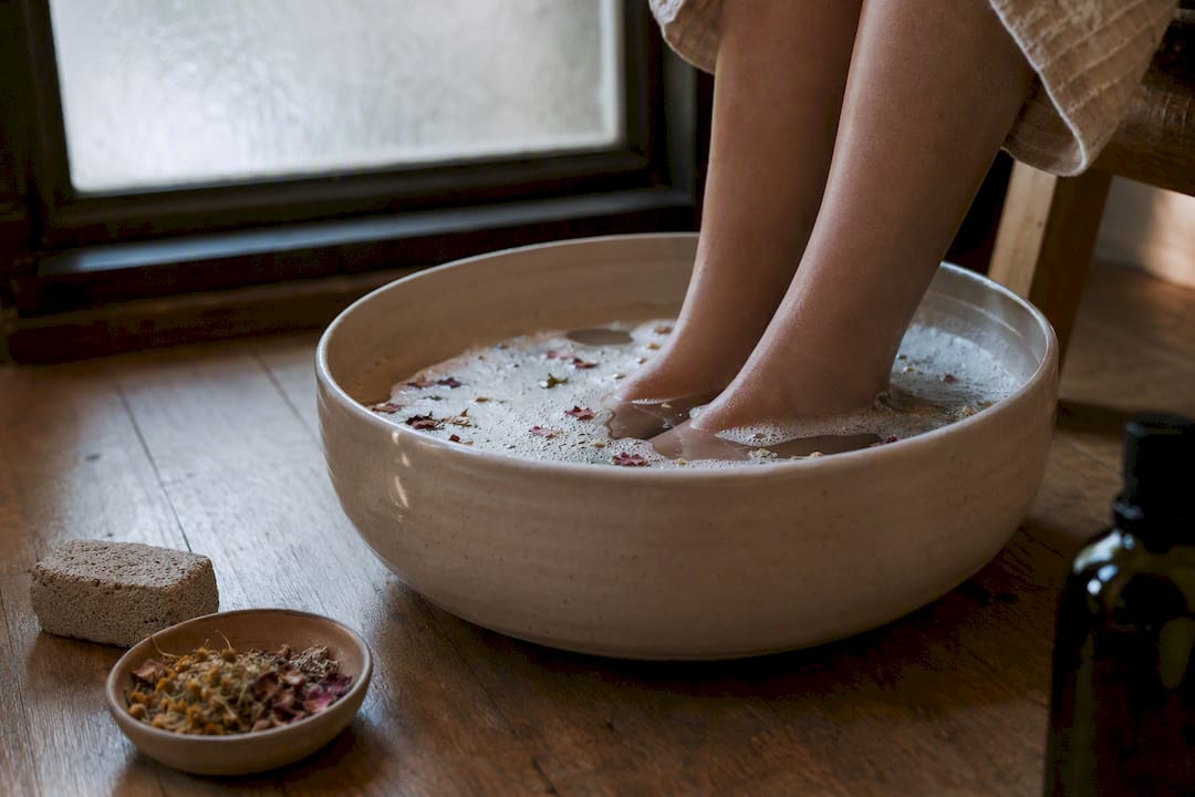 Feet soaking in botanical foot bath