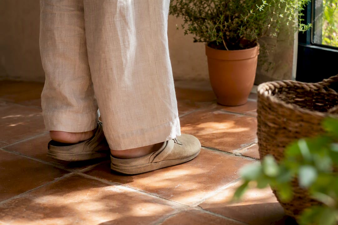 Worker's feet in cushioned shoes on hard floor