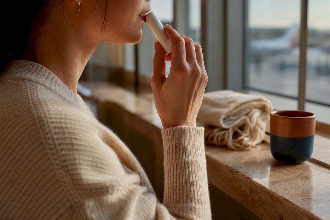Traveler using a personal aromatherapy inhaler
