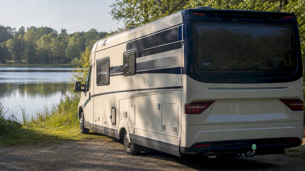 Parked motorhome with security tracker sticker outdoors