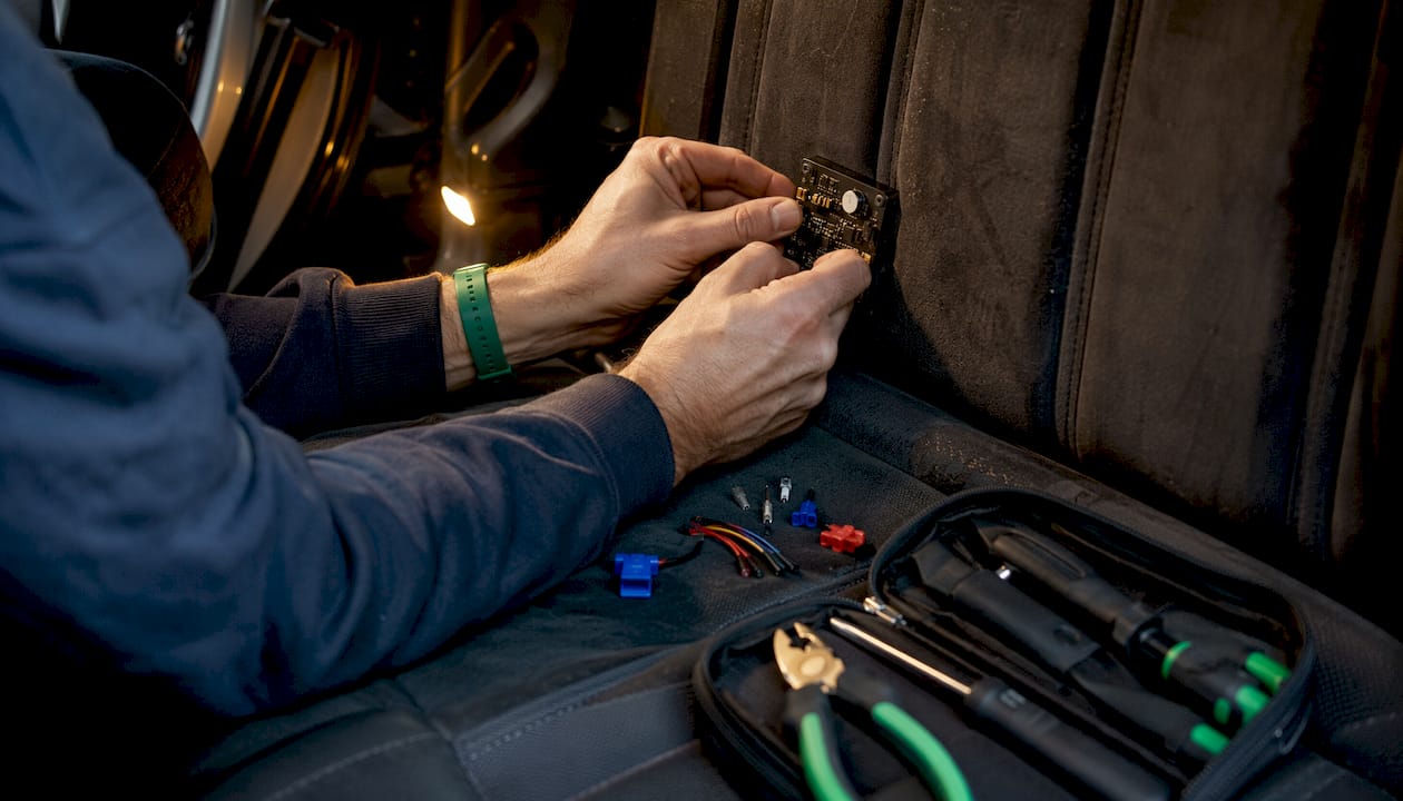 Hands holding GPS tracker with light sensor