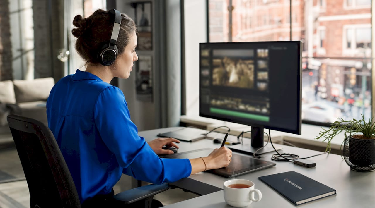 Wedding videographer editing footage at desk