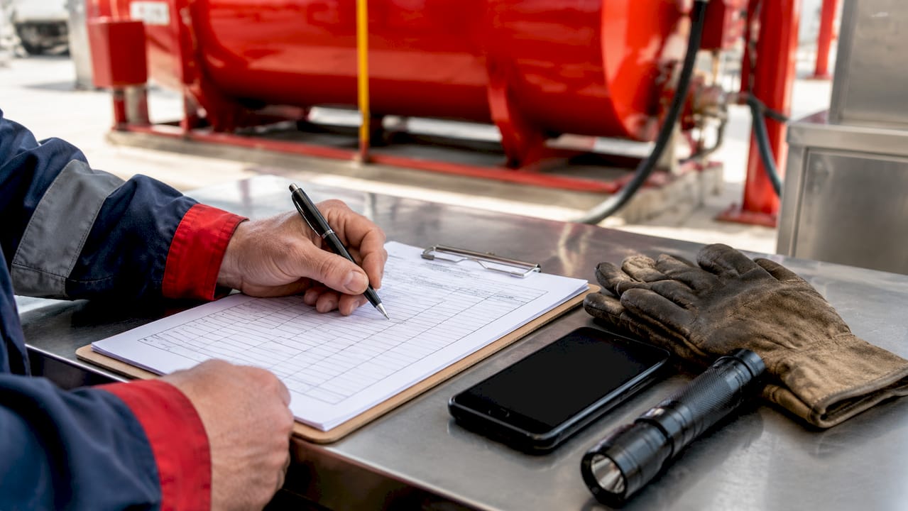 What Is Dyed Diesel Fuel? A Compliance Guide for Pros 1 Assessing fuel logs near dyed diesel container