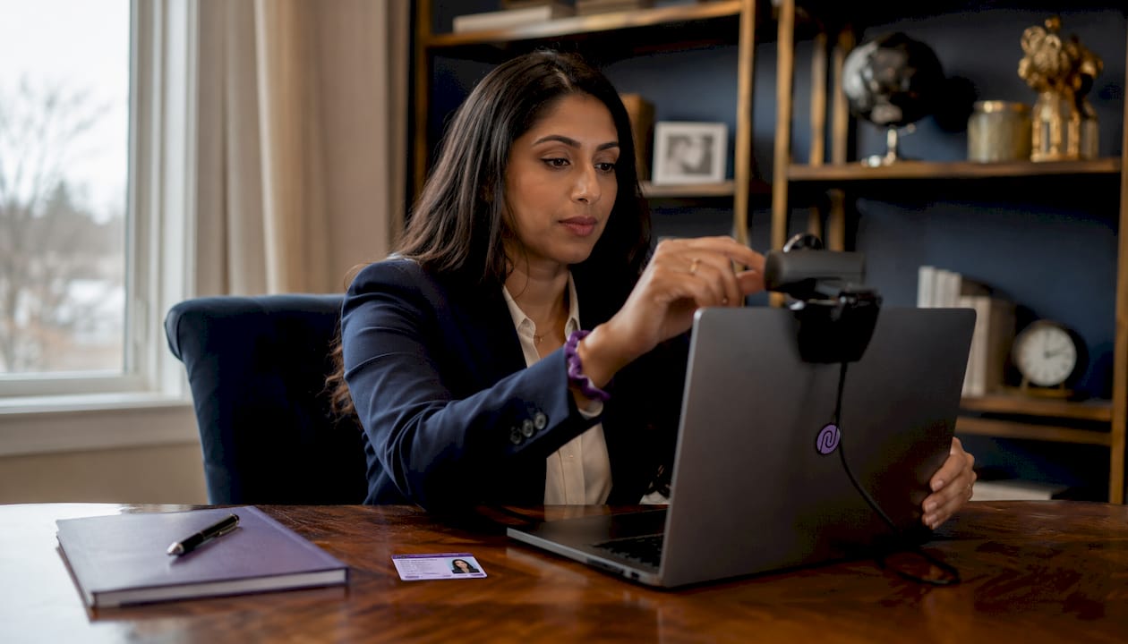 Woman testing laptop camera and microphone