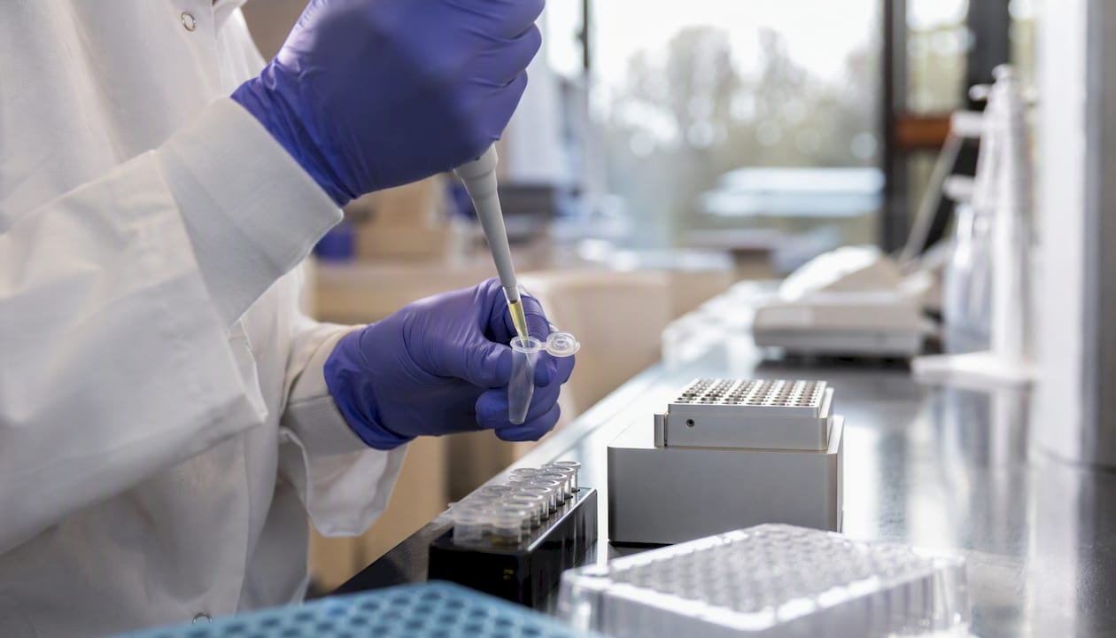 Technician pipetting liquid biopsy sample for NGS