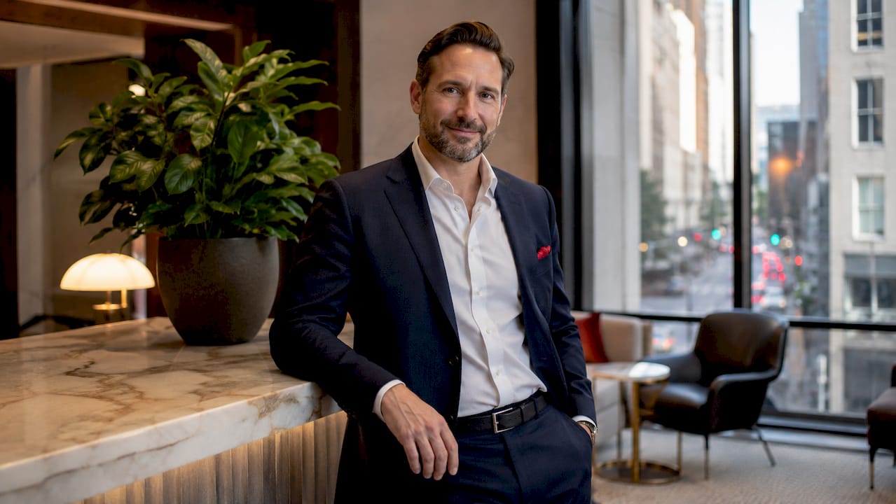 Male executive outdoors on office balcony with city view