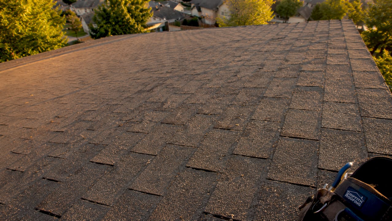 Close-up photo of sun-damaged roof shingles
