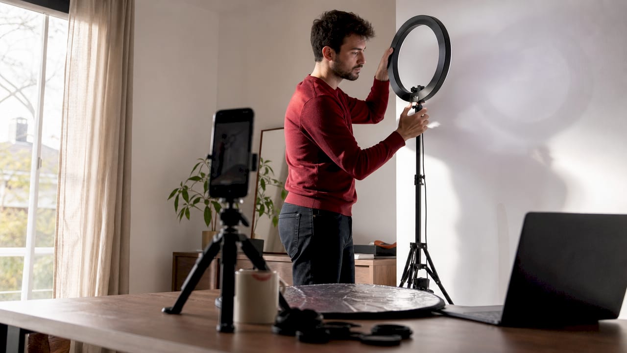 Man preparing DIY headshot lighting at home