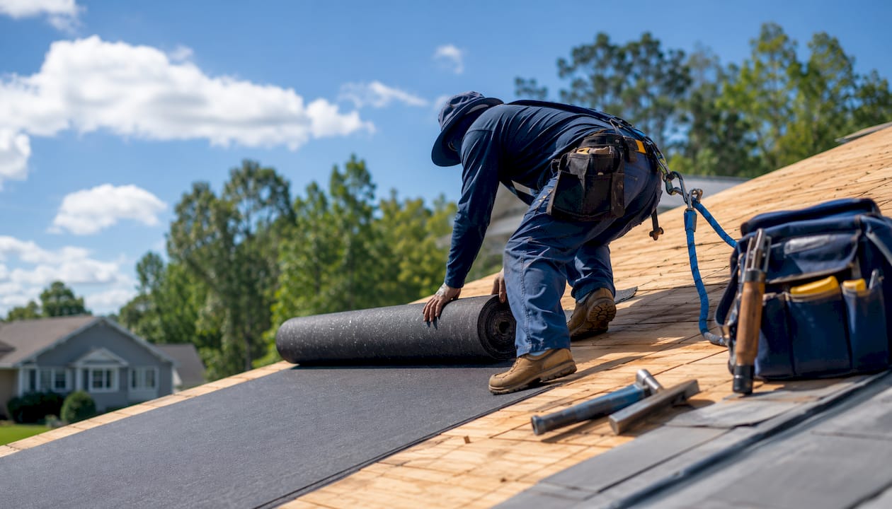 Roofing felt being installed under shingles