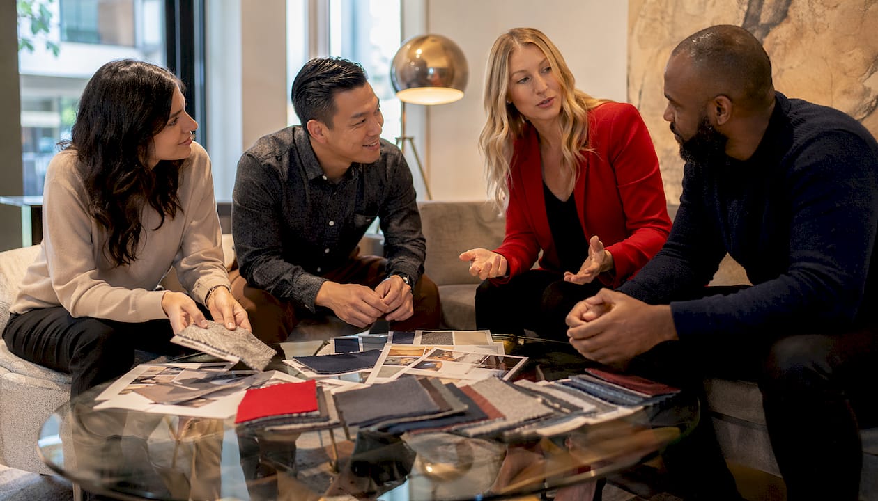 Team discussing headshot wardrobe in office