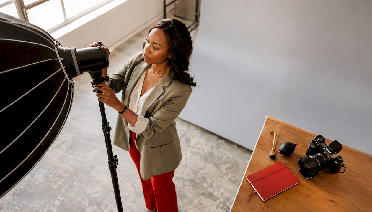 Photographer adjusting softbox light in studio