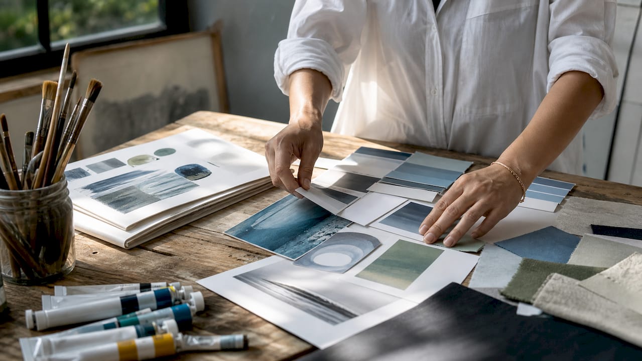 Designer selecting warm color palettes for wall art