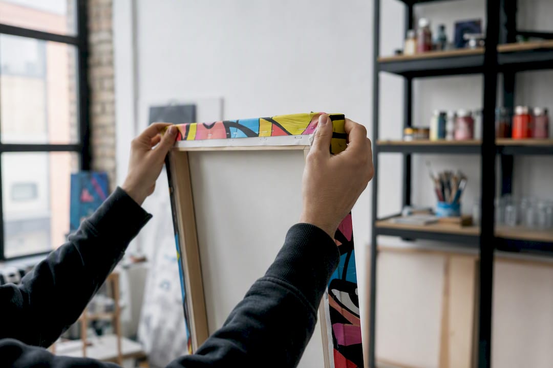 Hands adjusting gallery wrap canvas edge