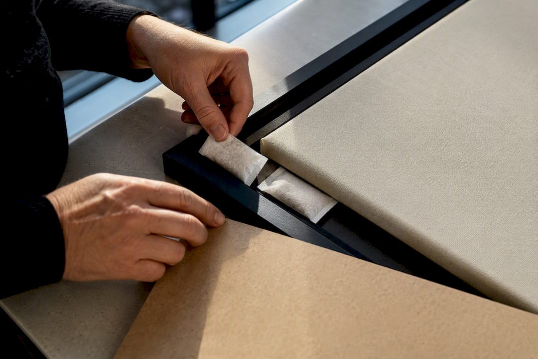 Hands placing silica packets in frame