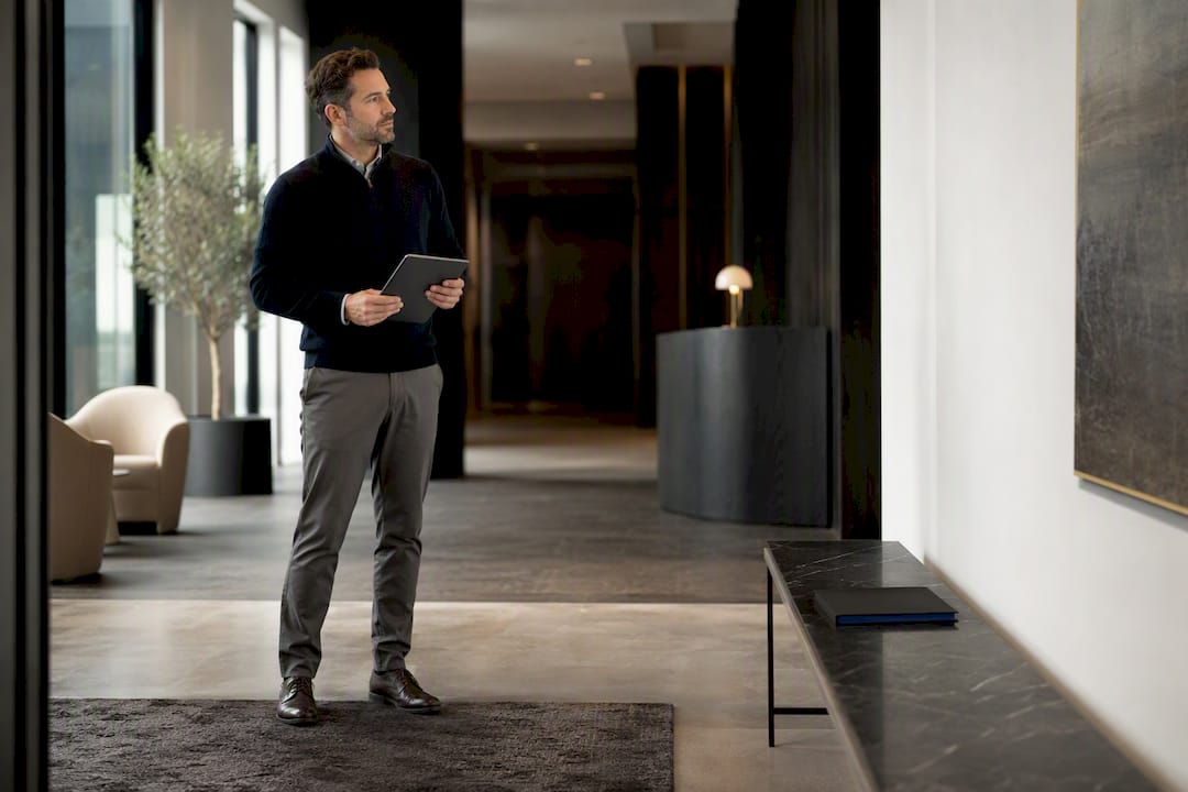 Manager assessing wall art from reception distance