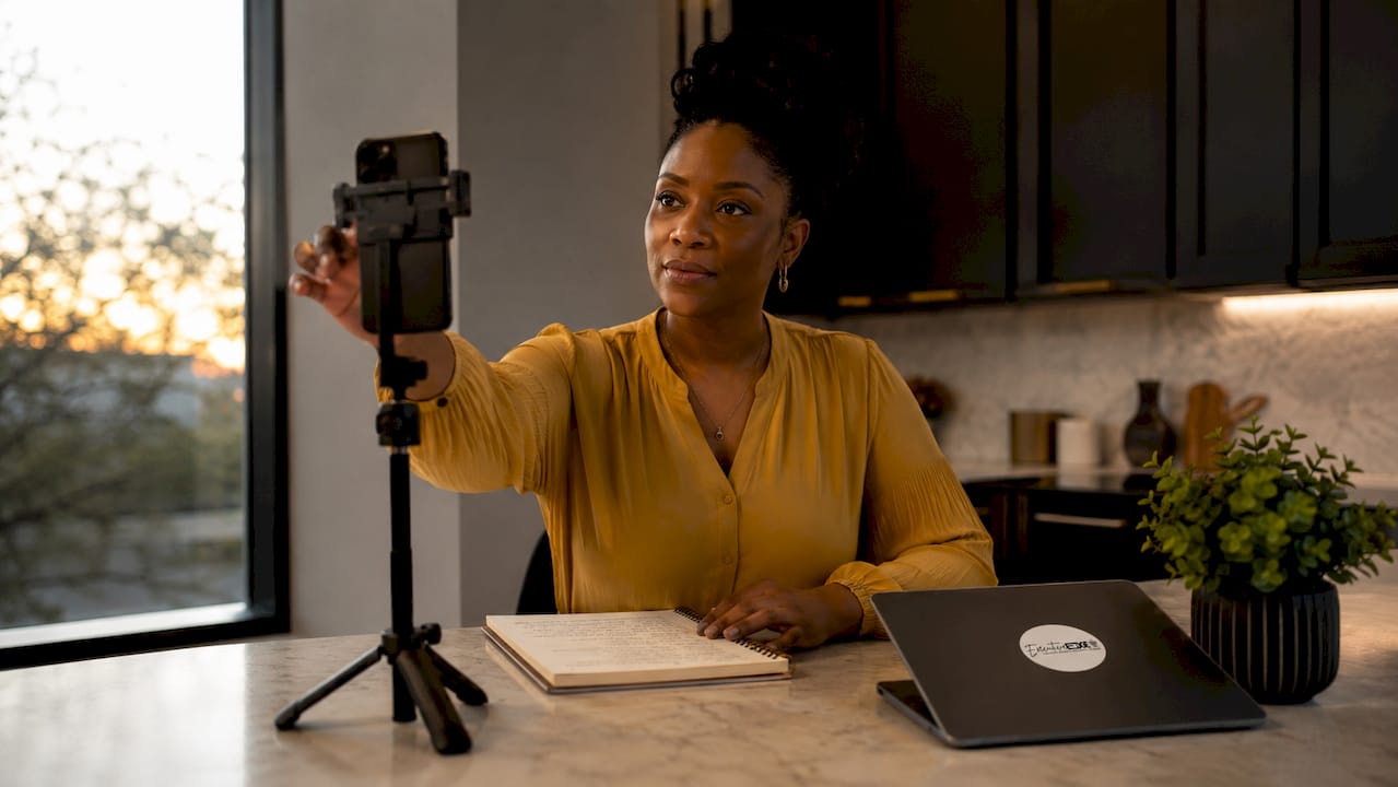 Woman setting up phone to record short-form video