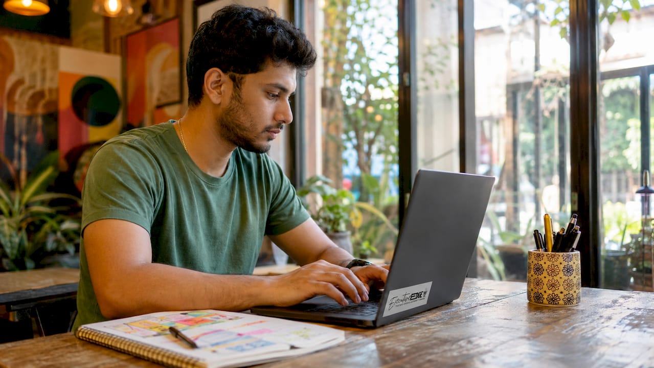 Hands typing on laptop for YouTube Studio management