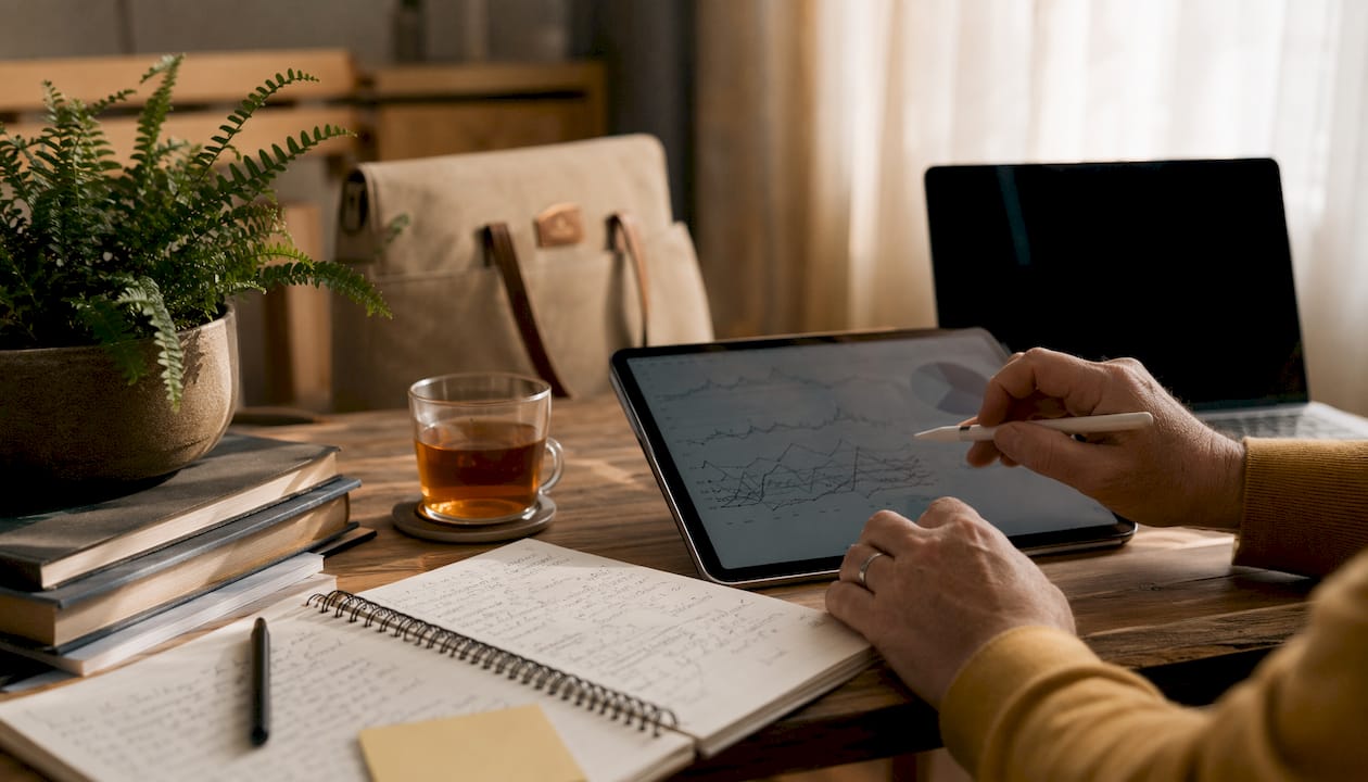 Overhead view of analytics tablet and notes