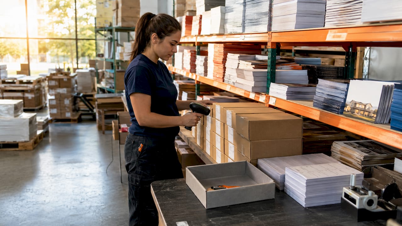 Warehouse worker preparing marketing materials for shipment