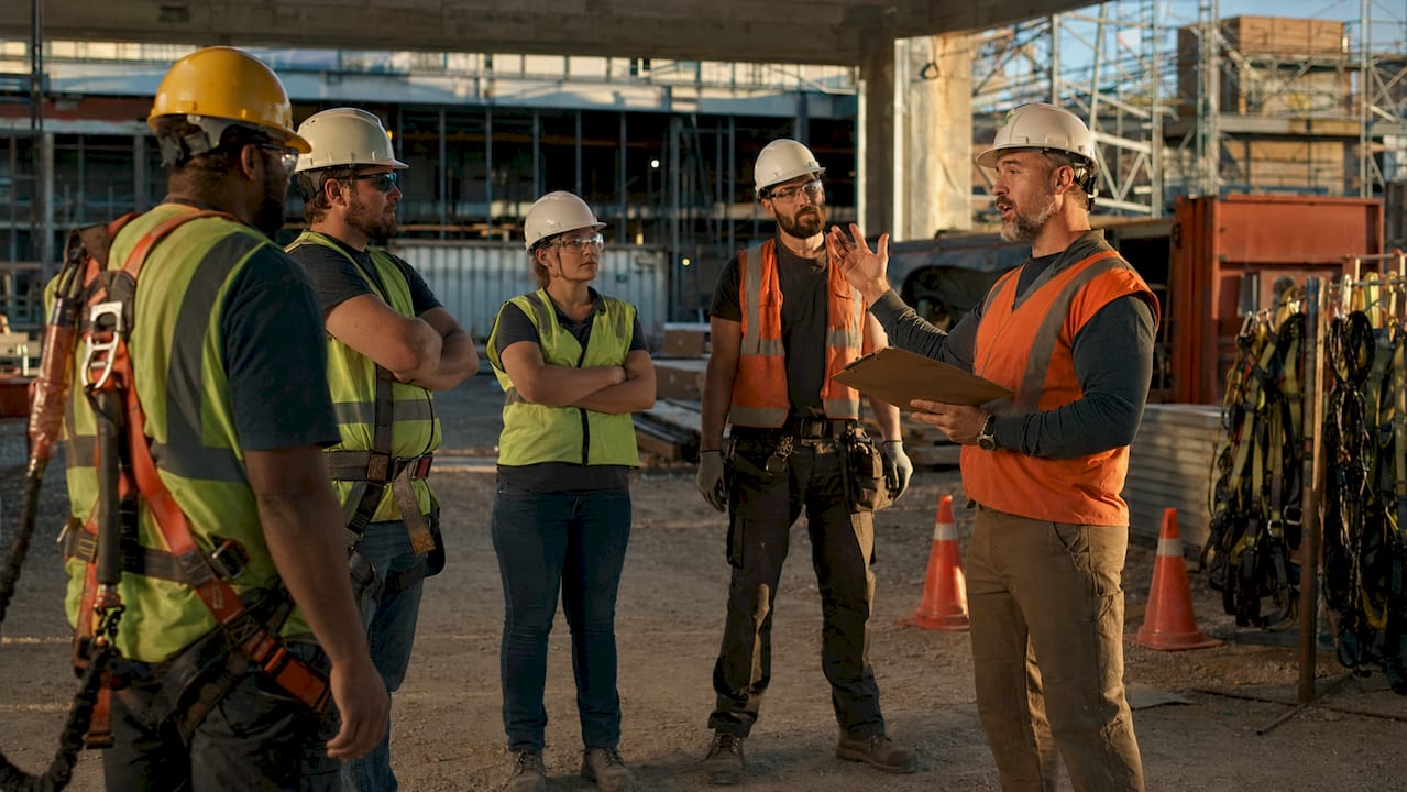 Supervisor leading construction safety toolbox talk