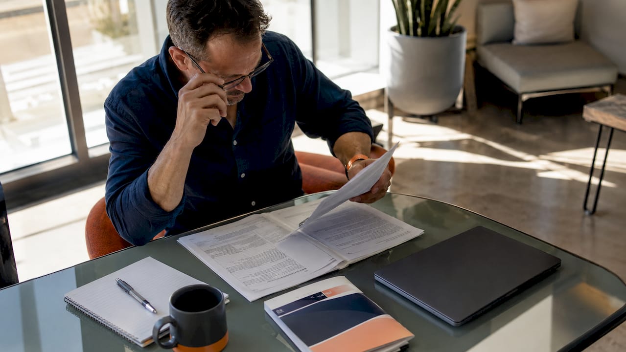 Small contractor reviewing government bid documents at desk