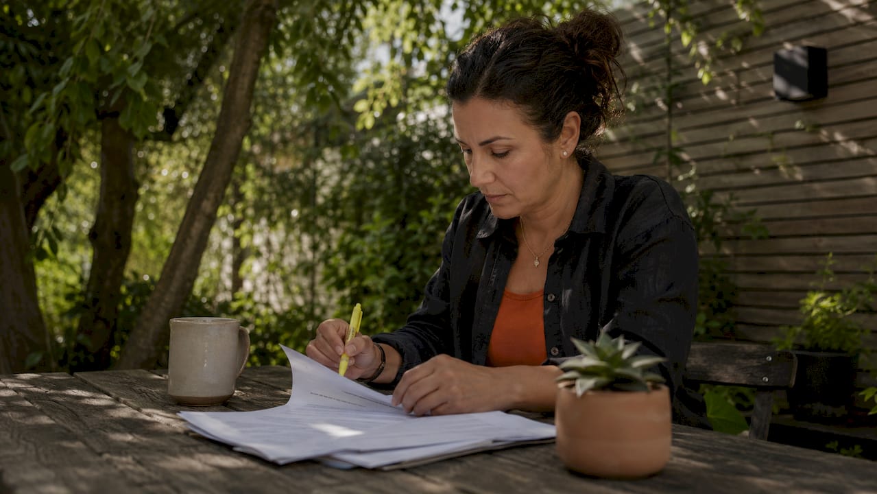 Contractor reviewing onboarding forms at office desk