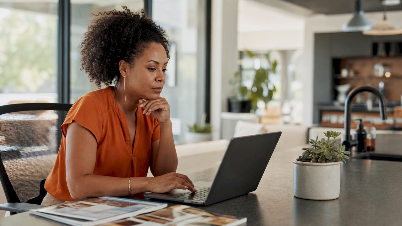 Woman working on construction CRM at desk