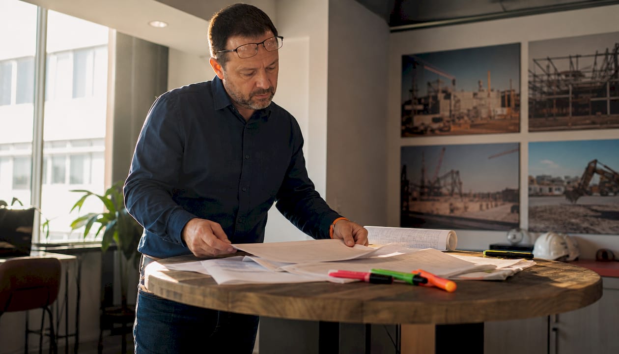 Project manager reviewing subcontractor withdrawal documents