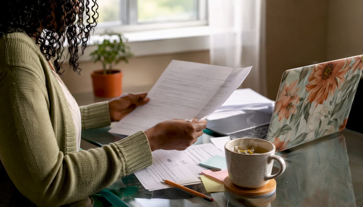 Hands organizing business registration documents on desk